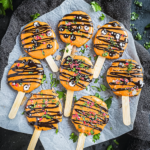 Halloween Monster Cookie Pops: Spooky and Fun Pumpkin-Flavored Cookie Pops Decorated with Candy Eyes and Chocolate Drizzle for Halloween Parties 3 Halloween Monster Cookie Pops: Spooky and Fun Pumpkin-Flavored Cookie Pops Decorated with Candy Eyes and Chocolate Drizzle for Halloween Parties